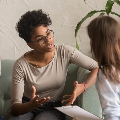 Unhappy african wife talking to psychologist complaining on bad relationship Unhappy jealous mixed-race wife talk to psychologist counselor complain on bad relationship with husband, african american family couple counseling have conversation about problem at therapy session
